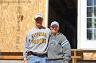 April and Matt in front of their log home which is currently under construction.