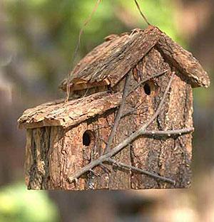 A bird house cabin made of tree bark, with an attached lean-to. bark-birdhouse-with-lean-to.jpg