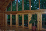 The wall of windows inside a log home for sale in Leiper's Fork, TN.