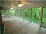 I fell in love with this fully-enclosed porch/sunroom..