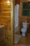 The tiny bathroom inside this log home.