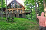 Jim checking out the exterior deck and balcony on this log home for sale in Leiper's Fork, TN.