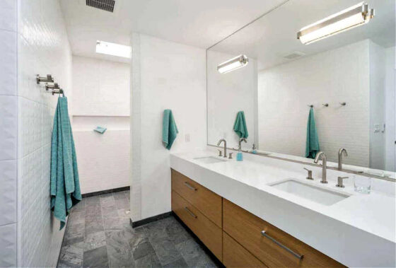 A large walk-in shower without any doors in the master bathroom.