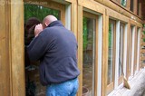 Jim peeking inside a log home... the first log home for sale that we ever stepped foot in!