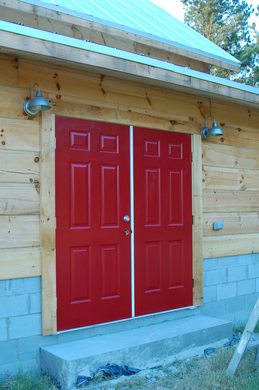 red-steel-doors-on-log-building-by-Justin-Shearer.jpg