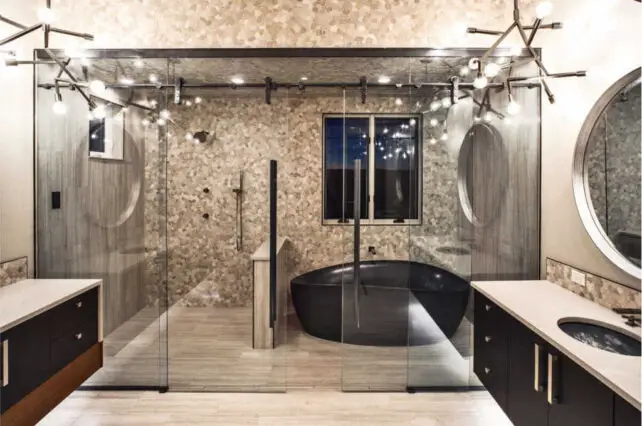 A master bathroom wet area - the walk-in shower and bathtub are both enclosed in a glass 'room'.