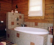 tiled-tub-wall-hides-toilet.jpeg