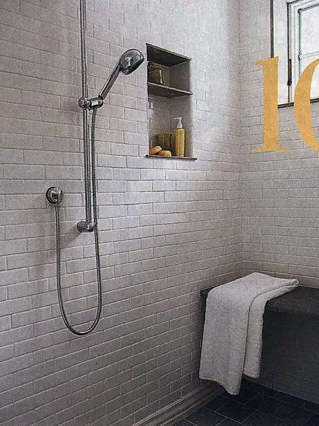 This is a nice spa shower inside the master bathroom, with a built-in shower seat and niche shelf for hair products -- as seen in This Old House magazine, May 2005.