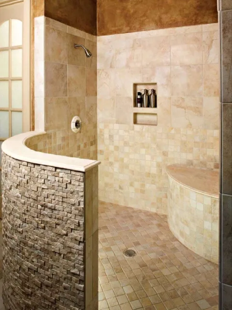 This is a doorless master shower with a curved rustic half wall -- as seen in a house for sale.