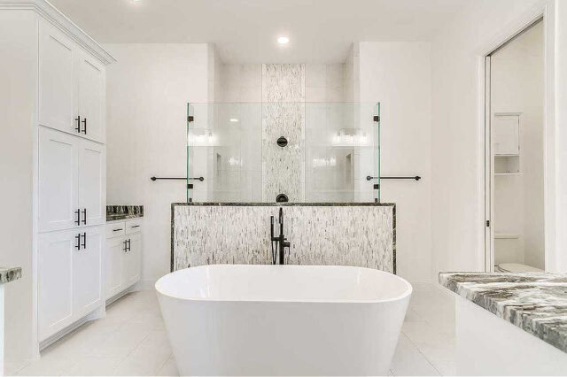 This is a super classy walk-thru shower for a master bathroom featuring a half-glass wall as the divider that separates the shower form the rest of the room.