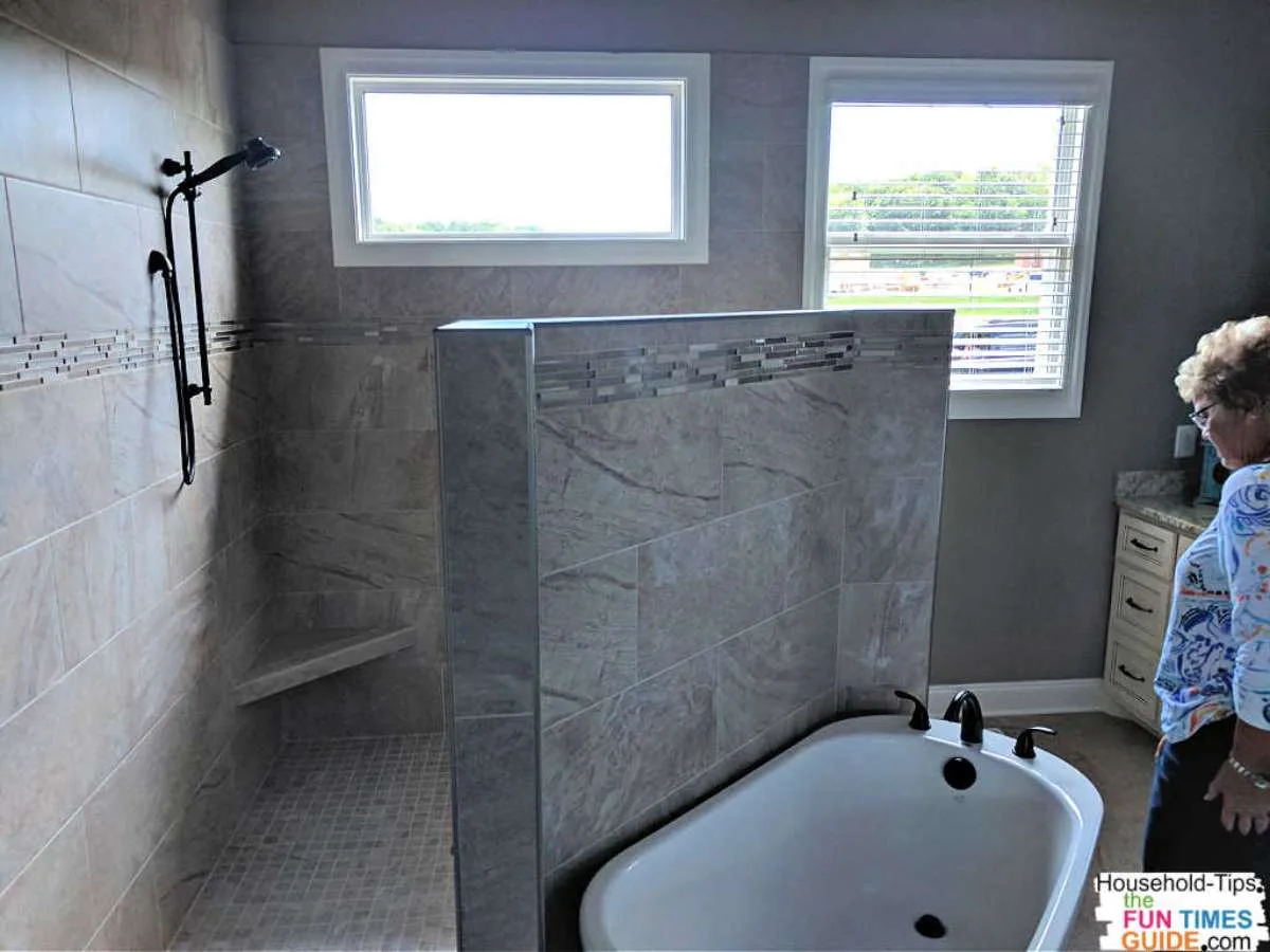 This doorless master shower uses a three-quarter height wall to separate the shower from the bathtub (and the rest of the room) -- as seen at a tour of homes in Nashville, TN.